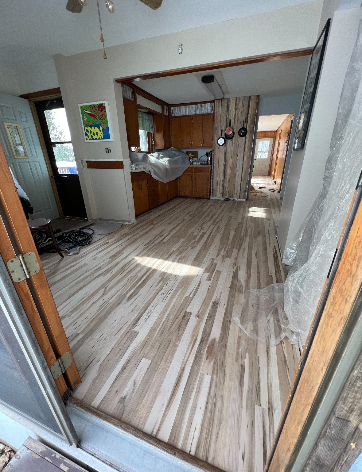 Solid Northern Maple hardwood flooring installed in living room – bright color, tight grain, mill-direct