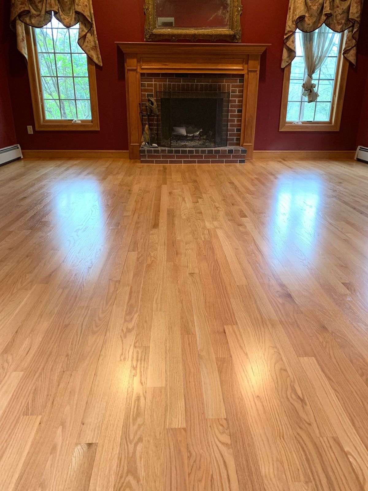 Red Oak Select hardwood flooring — solid wood, plain sawn, living room installation with fireplace